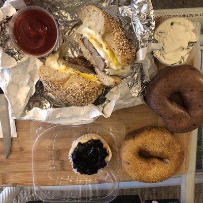 Saturday brunch spread: blueberry bagel, sun dried tomato bagel, egg sausage cheese bagel sandwich, and blueberry cheesecake for dessert