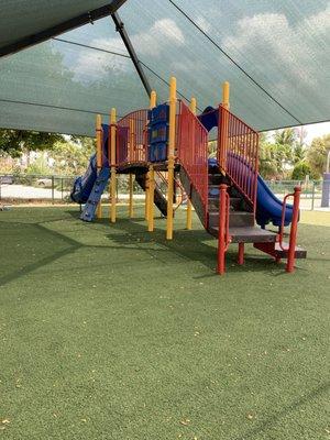 One of two covered playgrounds and this one is fenced all around.