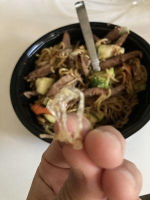 Plastic and a delicious steak yakisoba bowl