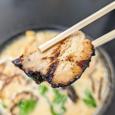 4/27/24 - Shoyu Tonkotsu Ramen. Chashu. Tons of flame-grilled charred flavor. Good teriyaki marinade. A little chewy. Uneven fat.