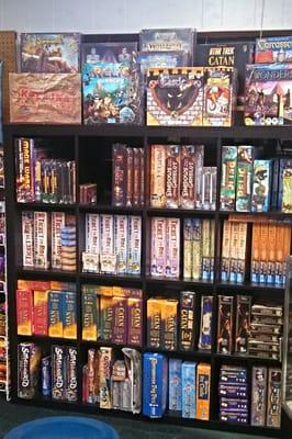 A nice selection of games, in some handsome shelving.