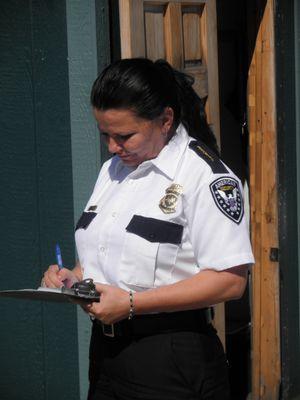 American Security Services security guard completing a sign in