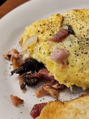 An Omelet with a freshly made potato chip.