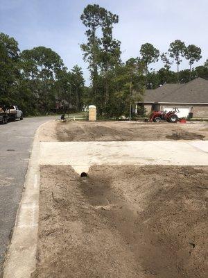 Made a sloping ditch and graded the front yard of a new construction house.