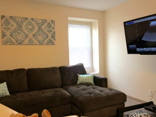 Comfy Ultrasound Room with Sectional Sofa and 50in Viewing Screen