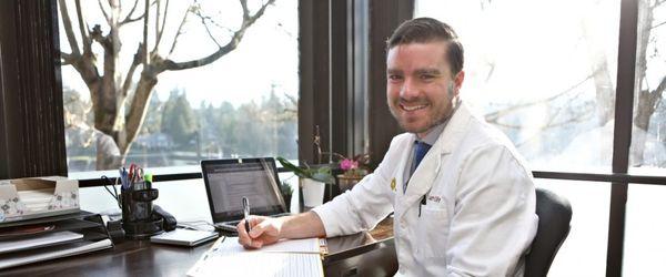 Dr. Samuel G. Oltman, ND, at his desk