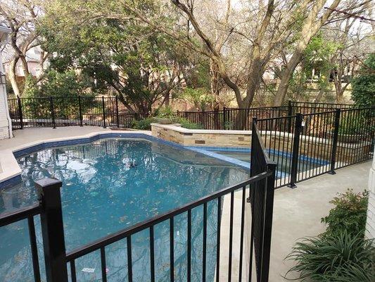 Iron pool fence with security gates over concrete in West Plano