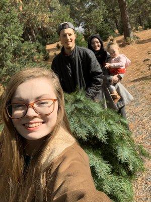 My sister, brother-in-law, and my niece carrying our Christmas tree at pine valley ranch