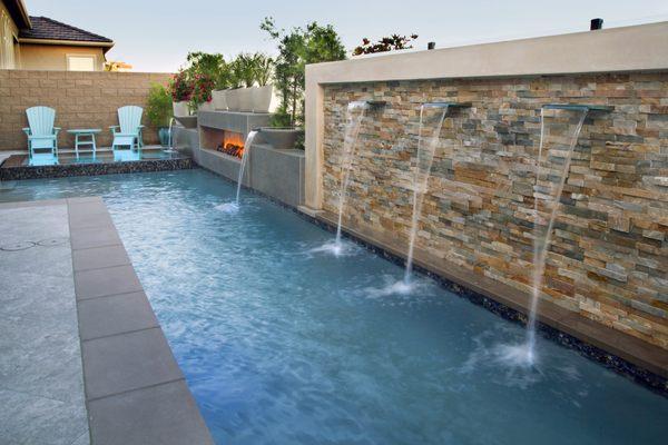 Geometric Pool with water features, a spa and a built-in fire pit