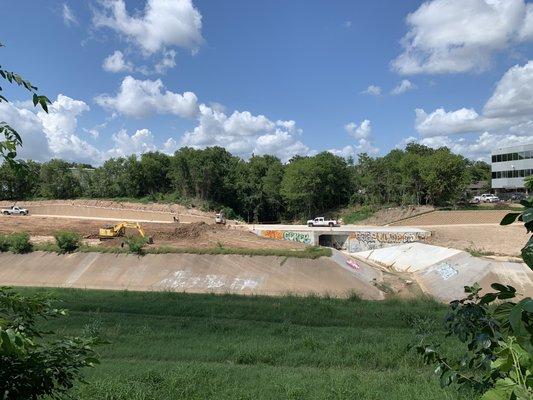 Behind the big hill, go down the steps to a sitting area overlooking the bayou.