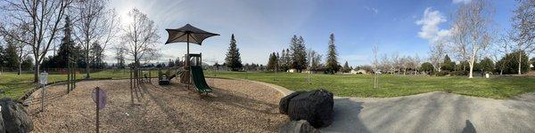 Panoramic view of older kid playground and field area