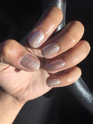 Glitter gold with pink glitter gel on ring finger manicure