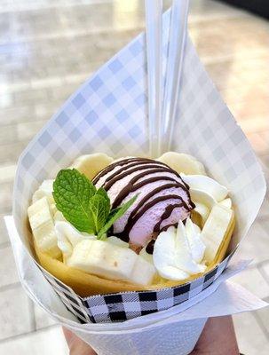 Banana, chocolate, whipped cream crepe with a scoop of strawberry ice cream