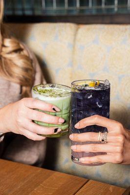 Two people clinking cocktail glasses