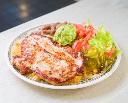 Chicken Breast Rice Plate comes with rice, beans, lettuce, and pico de gallo. Guacamole is extra charge.