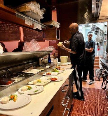 Seated along the counter with a front row seat to the kitchen.