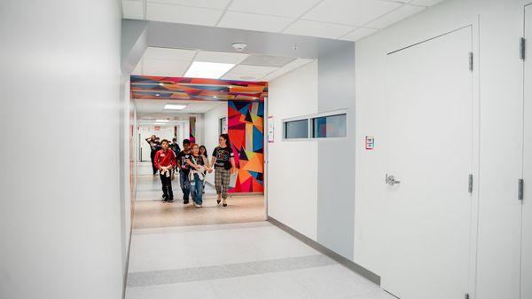 People walking down the hallway of CF Kids, which is the children program for the church.