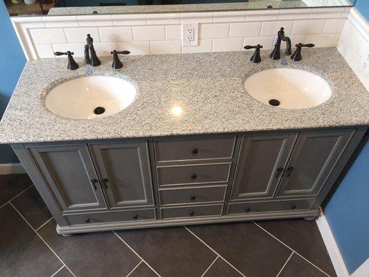 New Double vanity location, custom tile back splash, install vanity & top, connect all faucets.