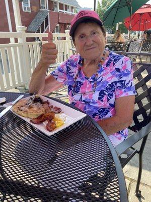 My mother enjoying her breakfast