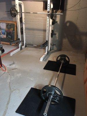 Olympic barbell and squat rack. I regularly squat 300 pounds and deadlift 400 pounds and this set up works just fine!!!!