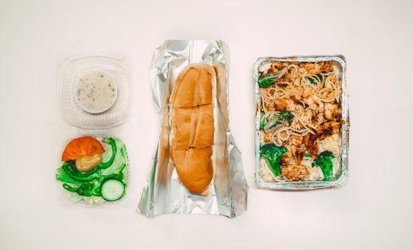 Homemade Chicken Broccoli Alfredo always served with garlic bread and side salad.