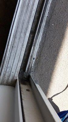 Dirt and sand filled tract on sliding balcony door