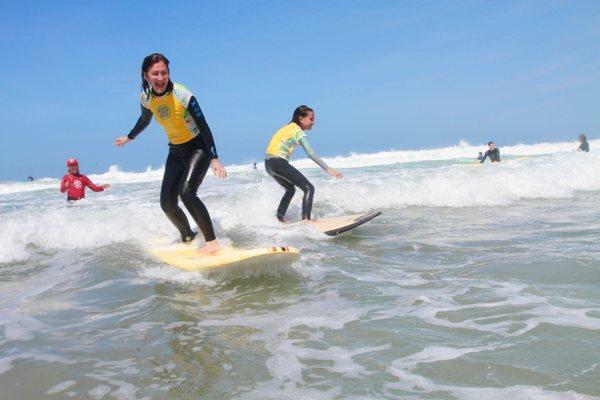 Mom & kids surfing together