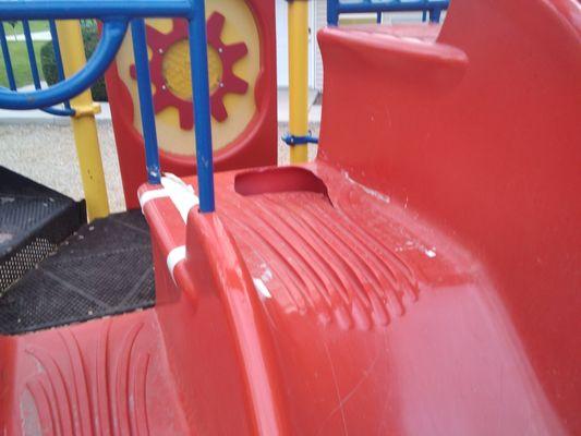 Large hole on playground slide.