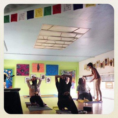 My twin daughters and me practicing Vinyasa yoga at Salas Studio Gallery with our instructor, Melody.