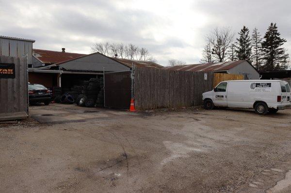 Back entrance of tire shop where you drive up to receive service, located on Atlantic Ave. Image was taken facing away from Green Bay Rd.