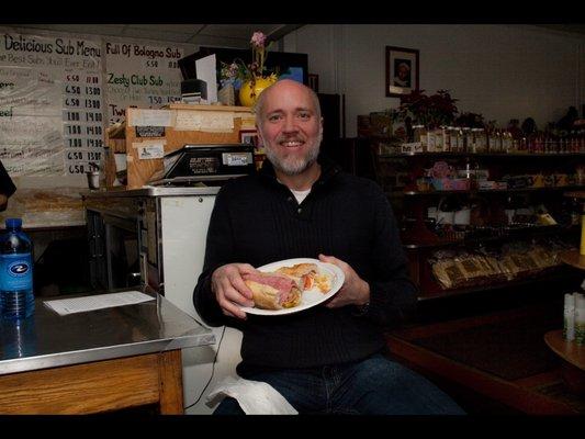 A very happy Leone'Market customer enjoying an Italian Submarine