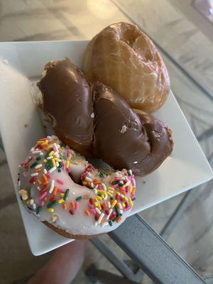 Chocolate twist, raspberry jelly, and cake donut with sprinkles