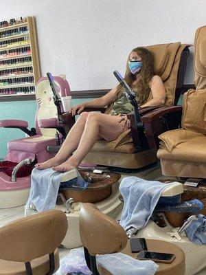 My daughter enjoying the massage chair.