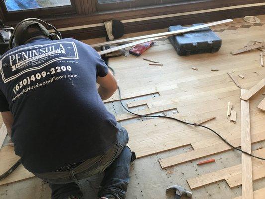 Repairs before restoring existing top-nail red oak hardwood floors.