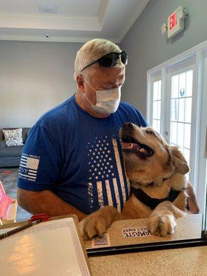 A veteran and his service dog Jax, get acupuncture.