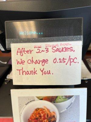 This is the sign showing the extra charge for sauces.