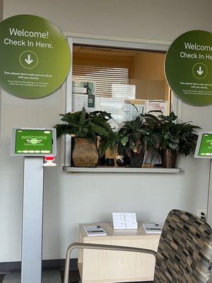 What used to be a receptionist window, covered by plants and no lights