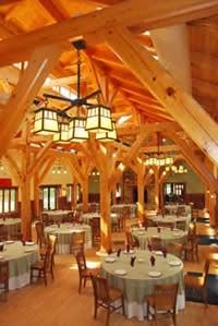 Majestic-pine-framed dining room with fireplace accommodates 140 persons for meals. Full commerical kitchen