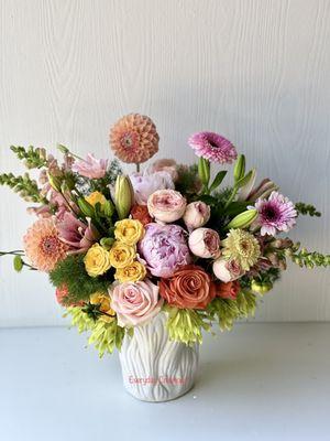 Beautiful peachy with Dahlias, peonies,garden spray rose, rose, snap dragon, lily, Gerbera, and fresh green.