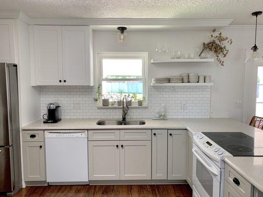 All new cabinets, open shelves. Backsplash and build out around the fridge.