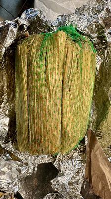 Tamales - green netting means spicy pork