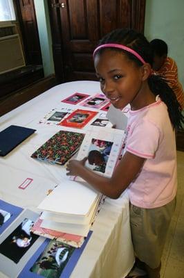 Hand-in-Hand Outreach Program participant putting the finishing touches on her memory book.