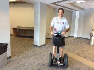 Dr. Charschan riding Kenny Chesney's segway while working back stage at the Chesney Concert helping treat crew members