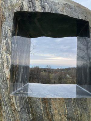 Cool sculpture with a view behind the building