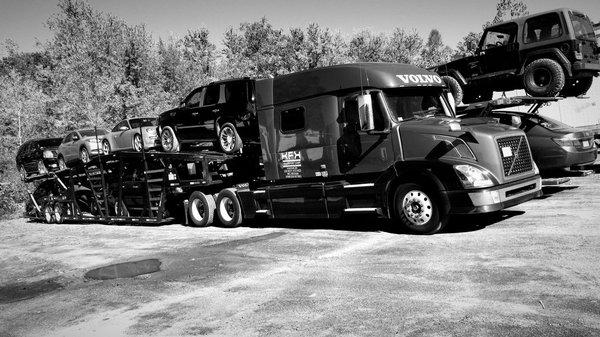 Volvo tractor trailer with a mixed load of SUV's and Sedans going to Texas