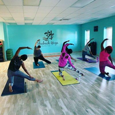 Students experiencing gate pose.