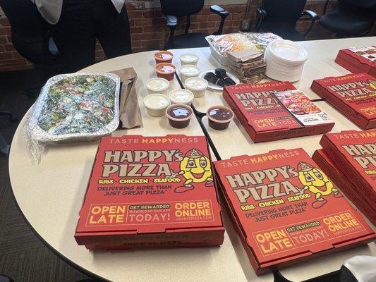 Pizza, salad, breadsticks and bbq sauce, hot sauce and dressing.