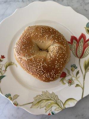 Sesame bagel on a 10 inch plate