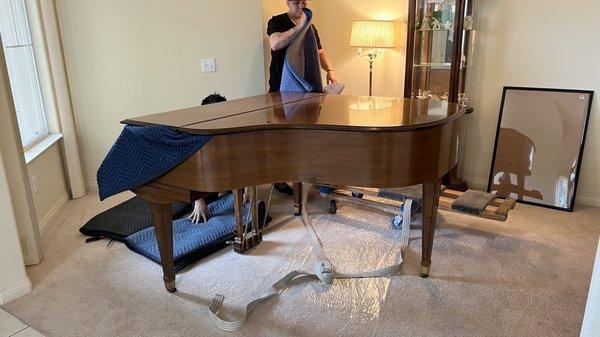 Preparing piano for transportation.