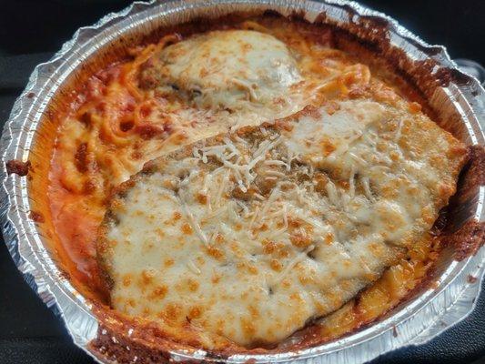 Eggplant parmesan over spaghetti